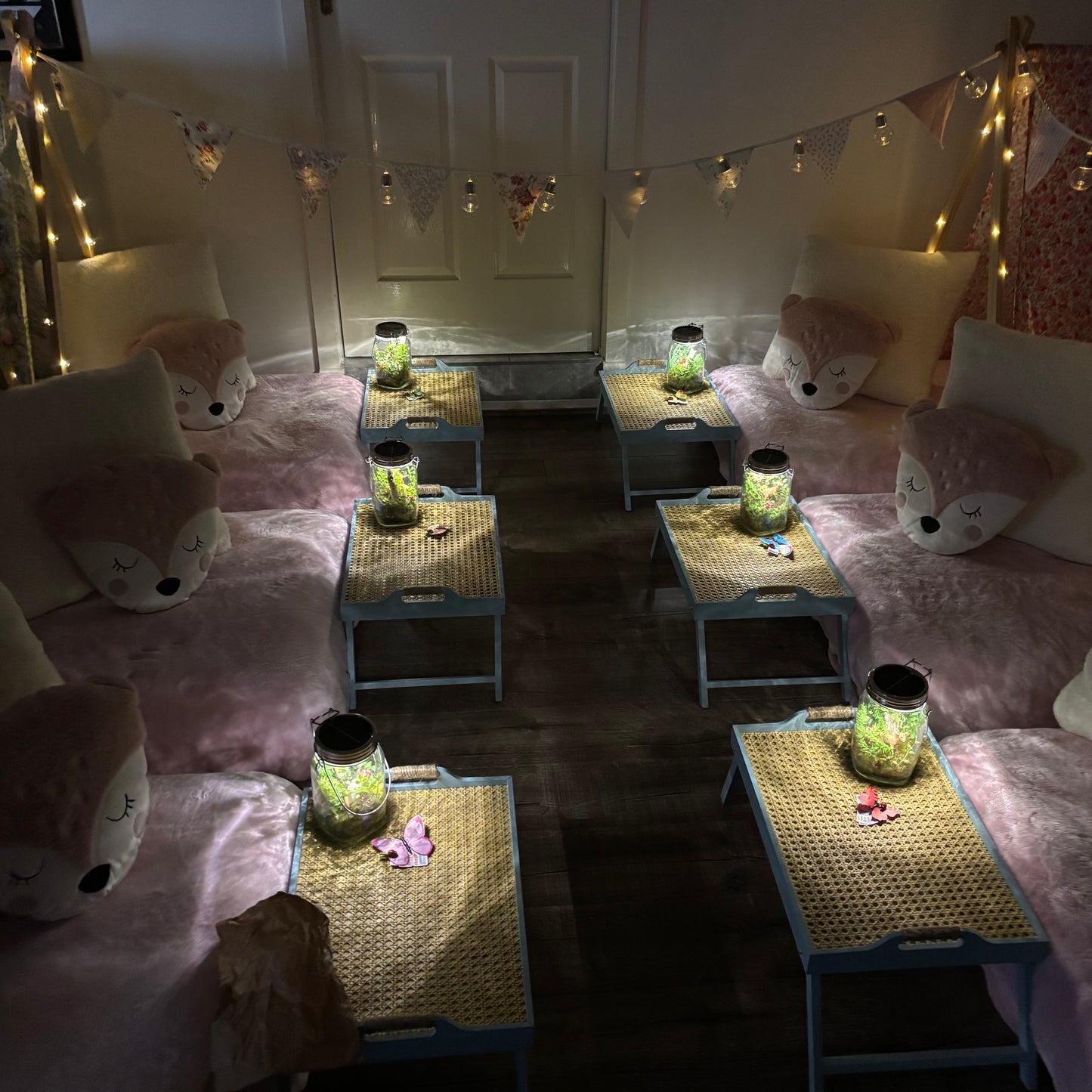 Six (6) colourful cute teepees with bunting, pink blanket, and twinkle lights set up for a luxury indoor slumber party in Melbourne