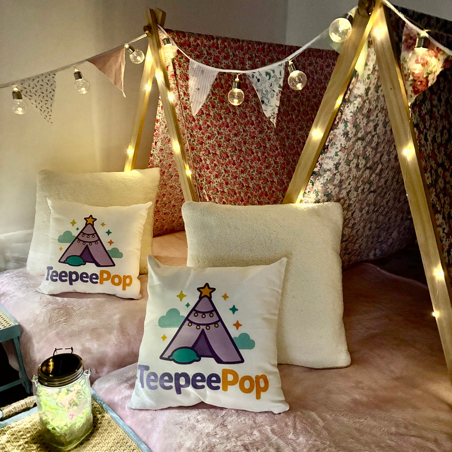 Six (6) colourful cute teepees with bunting, pink blanket, and twinkle lights set up for a luxury indoor slumber party in Melbourne