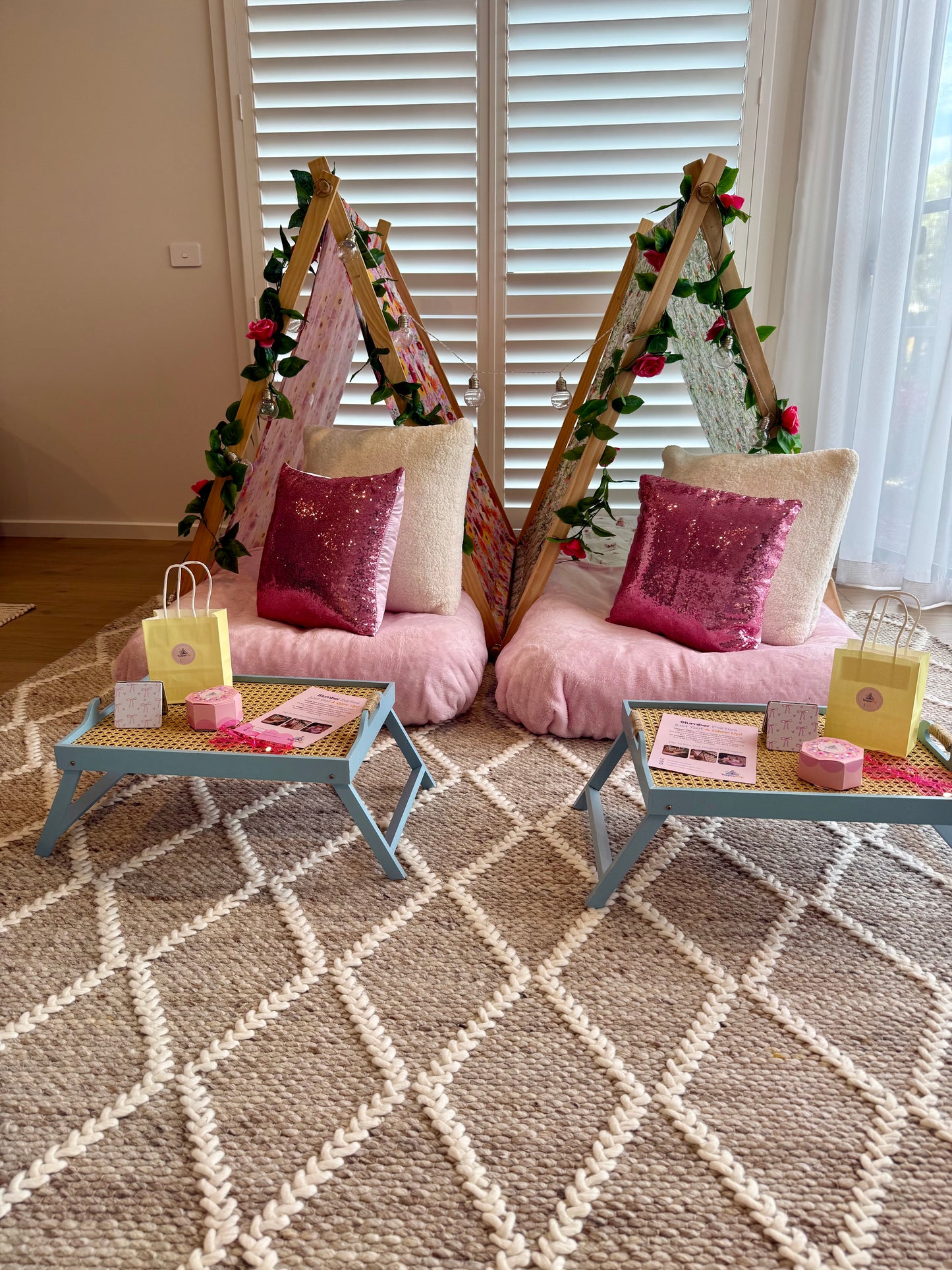 Flamingo-themed teepee setup with pink tents, pink bedding, and flamingo cushions for a cute ultimate girls’ sleepover