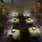 Six (6) colourful cute teepees with bunting, pink blanket, and twinkle lights set up for a luxury indoor slumber party in Melbourne