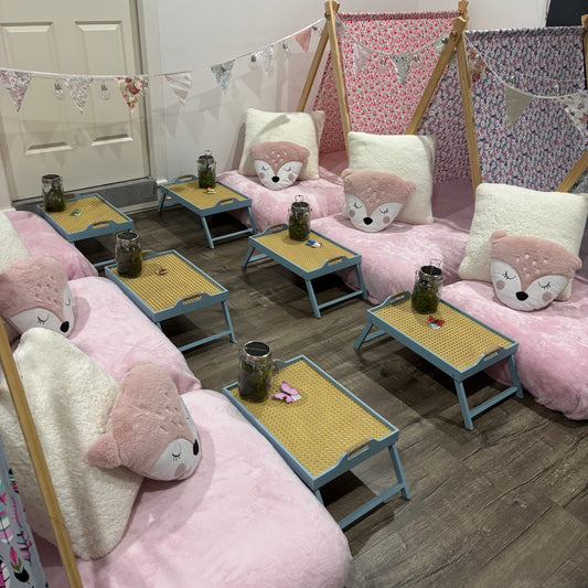 Six (6) colourful cute teepees with bunting, pink blanket, and twinkle lights set up for a luxury indoor slumber party in Melbourne