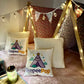Six (6) colourful cute teepees with bunting, pink blanket, and twinkle lights set up for a luxury indoor slumber party in Melbourne