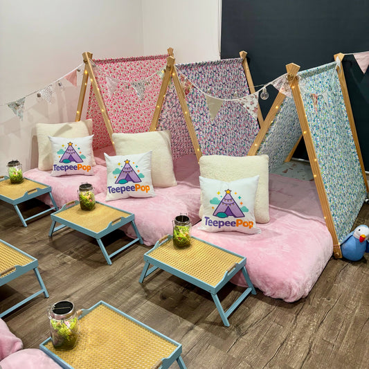 Six (6) colourful cute teepees with bunting, pink blanket, and twinkle lights set up for a luxury indoor slumber party in Melbourne