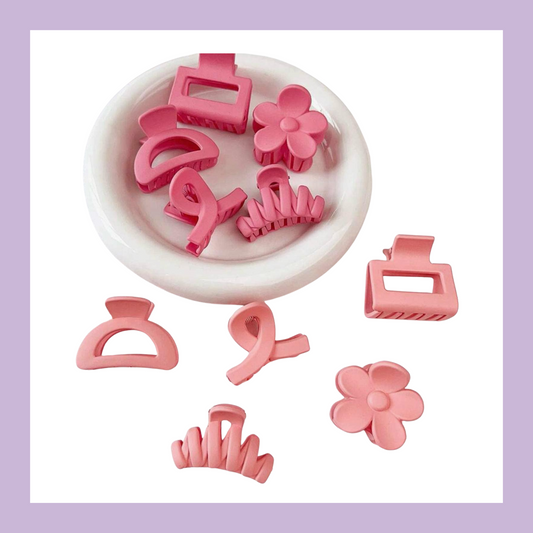 Kids assorted hair clips in colour light pink and hot pink. Designs include flower, claw clip, swirl pattern, etc.