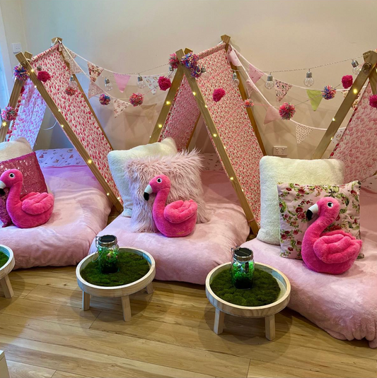 Three matching cute teepees with cushions, comfy blanket, and twinkle lights set up for a luxury indoor slumber party in Melbourne, Victoria.